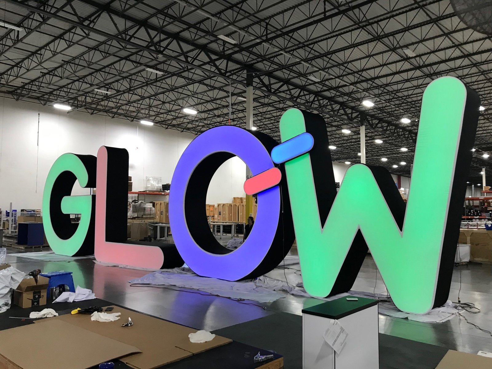 16 foot tall dimensional letters made from tube and fabric that spell GLOW. These are illuminated from inside the structure and look amazing.