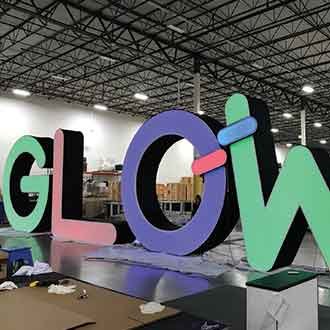 Large dimensional fabric letters that reads GLOW
